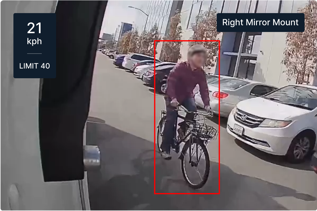 Dashboard view showing cyclist on street with parked cars, speed display showing 13 mph in 25 mph zone.