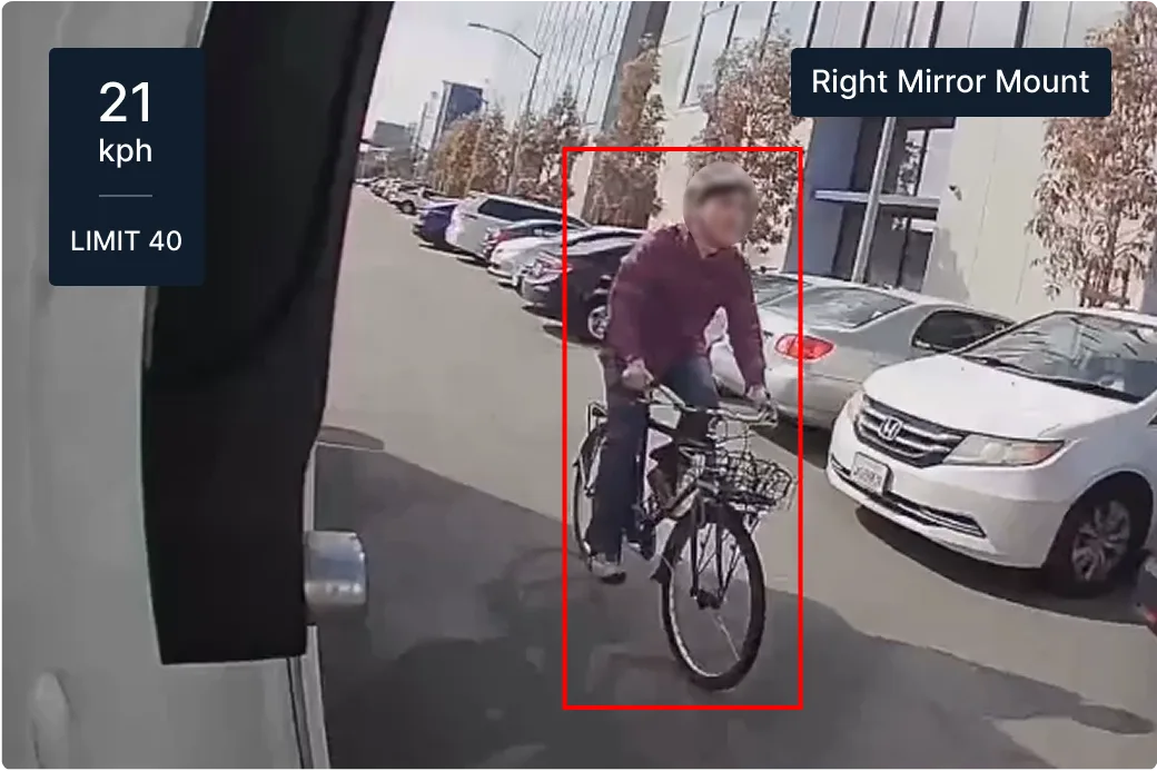 Dashboard view showing cyclist on street with parked cars, speed display showing 13 mph in 25 mph zone.