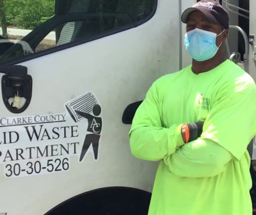 Person standing next to Athens Clarke County Truck