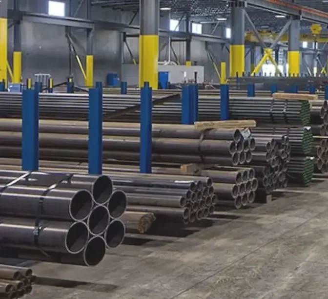 Industrial warehouse with stacked metal pipes and tubes organized on racks with blue and yellow support columns.