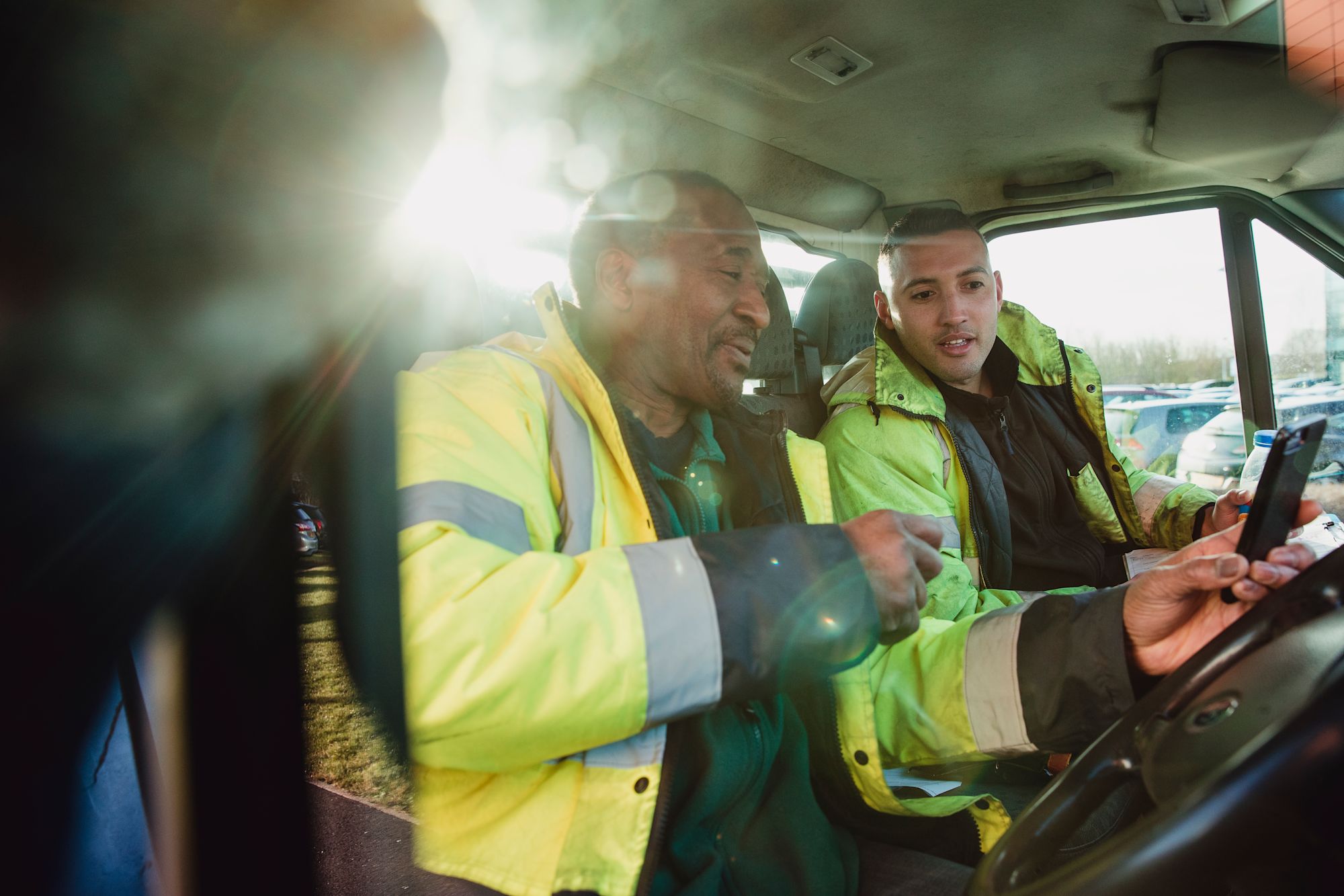 Drivers in cab with phone