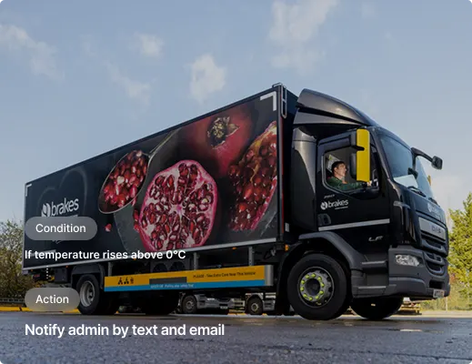 White semi-truck trailer on motorway with temperature alert interface showing condition and action notifications.
