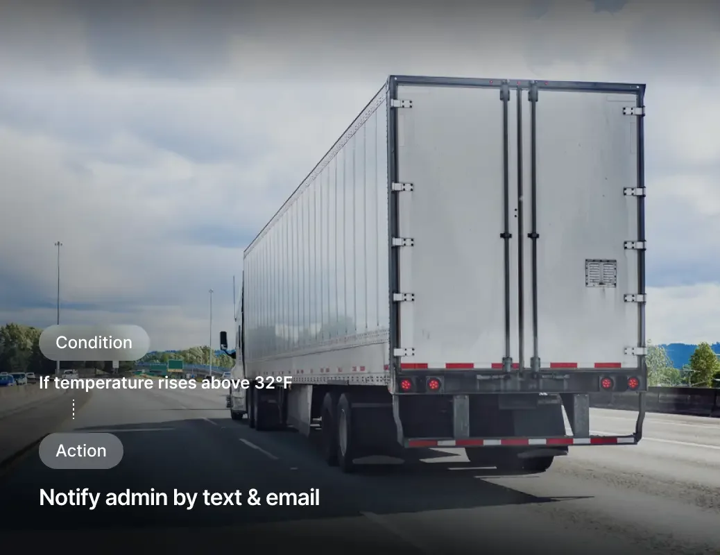 White semi truck trailer on highway with temperature alert interface showing condition and action notifications.