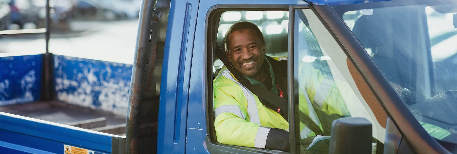 Driver driving a blue truck 