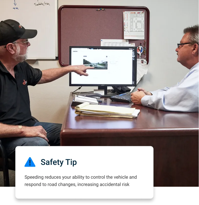 Back office workers assessing and discussing on-the-road video footage together.