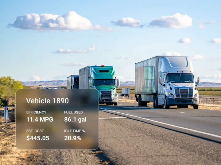 Two semi-trucks drive side by side on a highway under a blue sky with data overlay on one truck.

