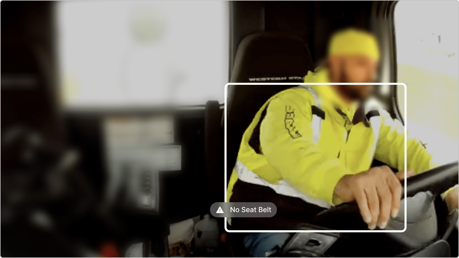 Person in bright yellow safety jacket driving without seatbelt, with warning notification visible.