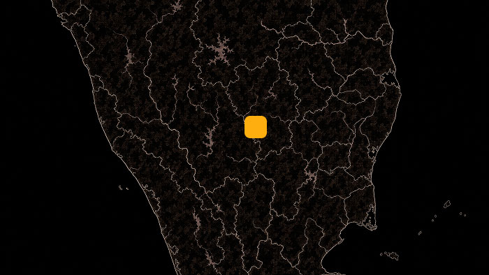 Dark map of a region with an orange square marker highlighting a central location.