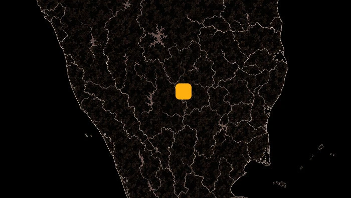 Dark map of a region with an orange square marker highlighting a central location.
