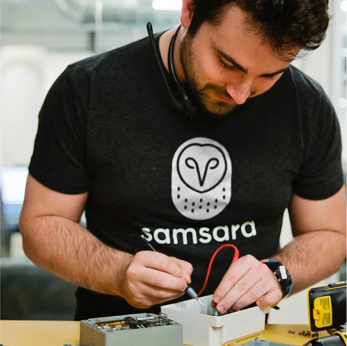 Samsara employee working with an IoT device