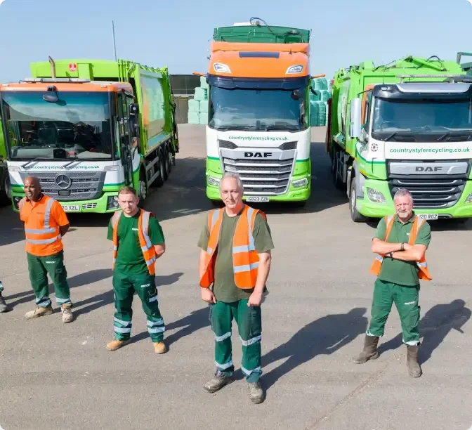 Workers in high-visibility vests and green uniforms standing in front of green and orange recycling lorries.
