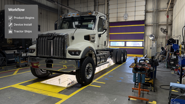 White semi truck in a maintenance facility with workflow steps showing Product Begins, Device Install, and Tractor Ships.