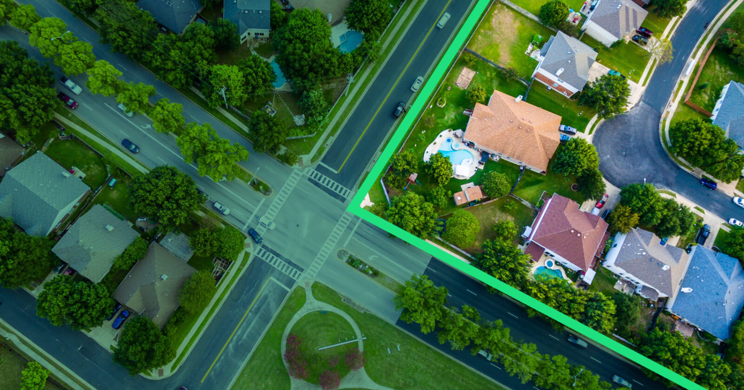 Drone Photo of a Neighborhood with Streets Lined in Green