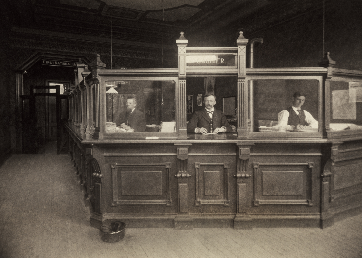 Antique photograph of a cashier at a bank teller’s window - Underwood Archives // Getty Images