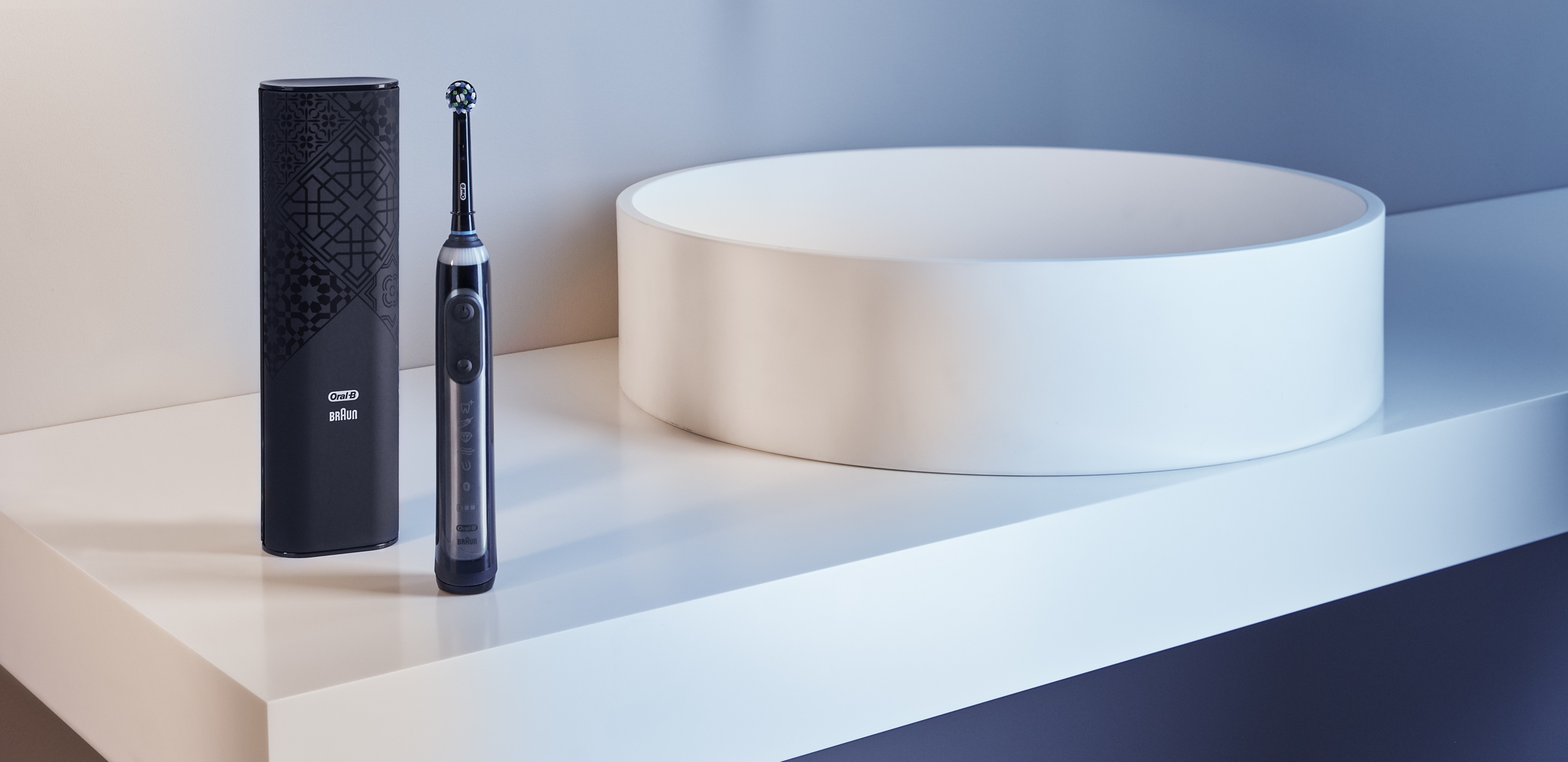 Black Oral-B Genius X toothbrush on a white countertop undefined