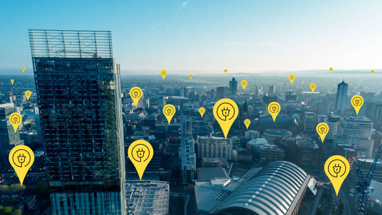 Electric charge point icons dotted across the Manchester skyline 