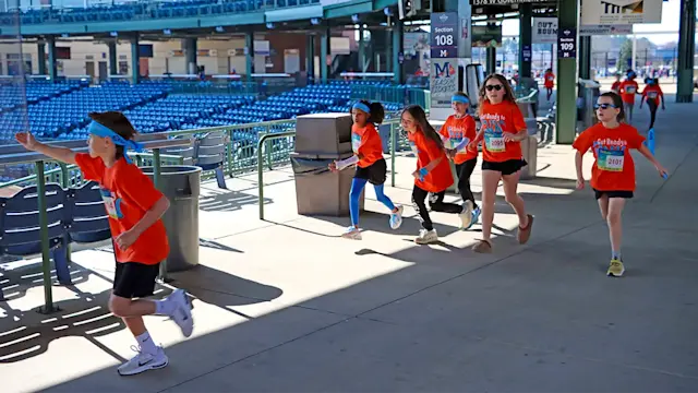 3rd graders running through Trustmark Park.