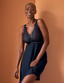 Smiling model in navy and lurex nightdress