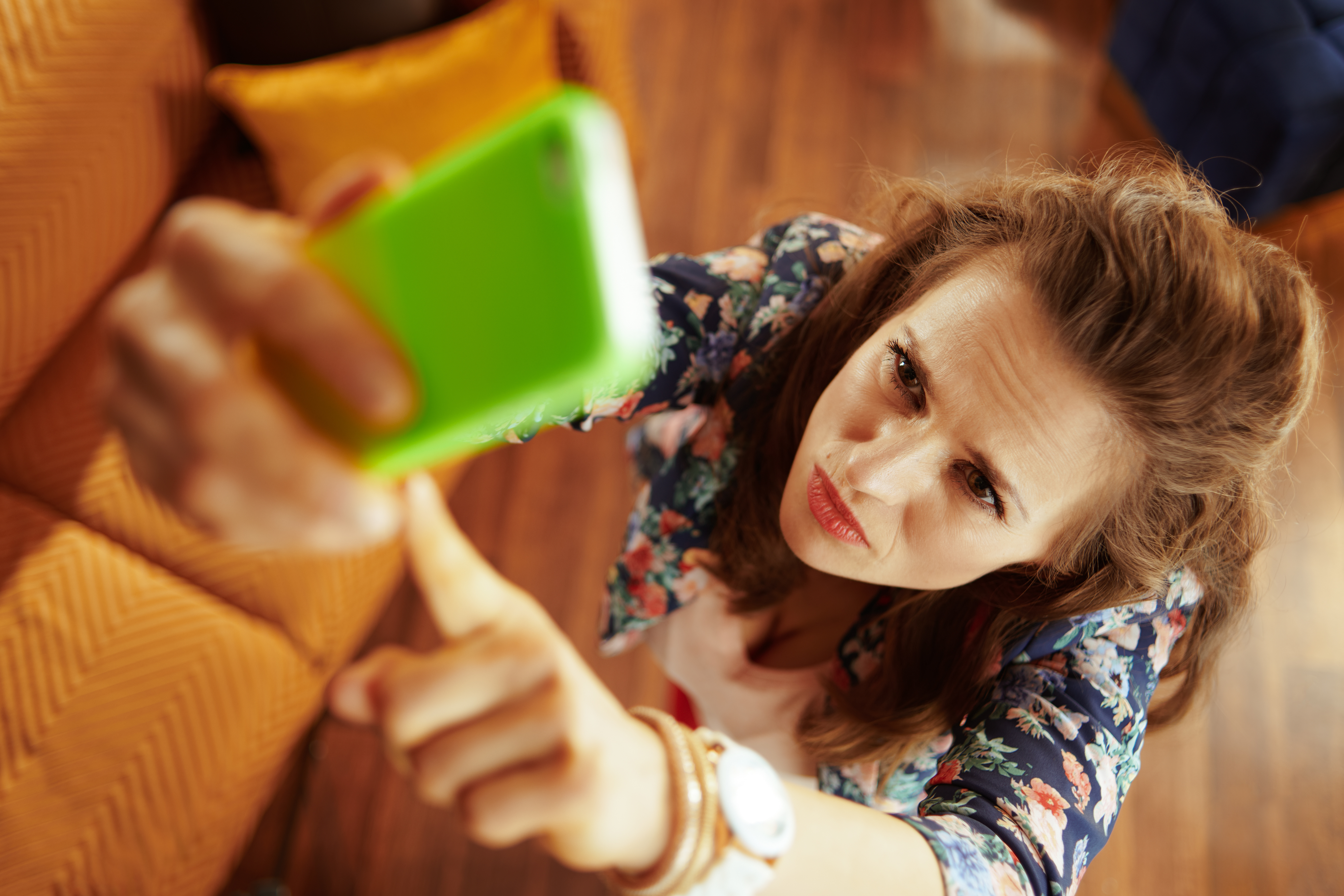 Woman home trying to get better signal smartphone