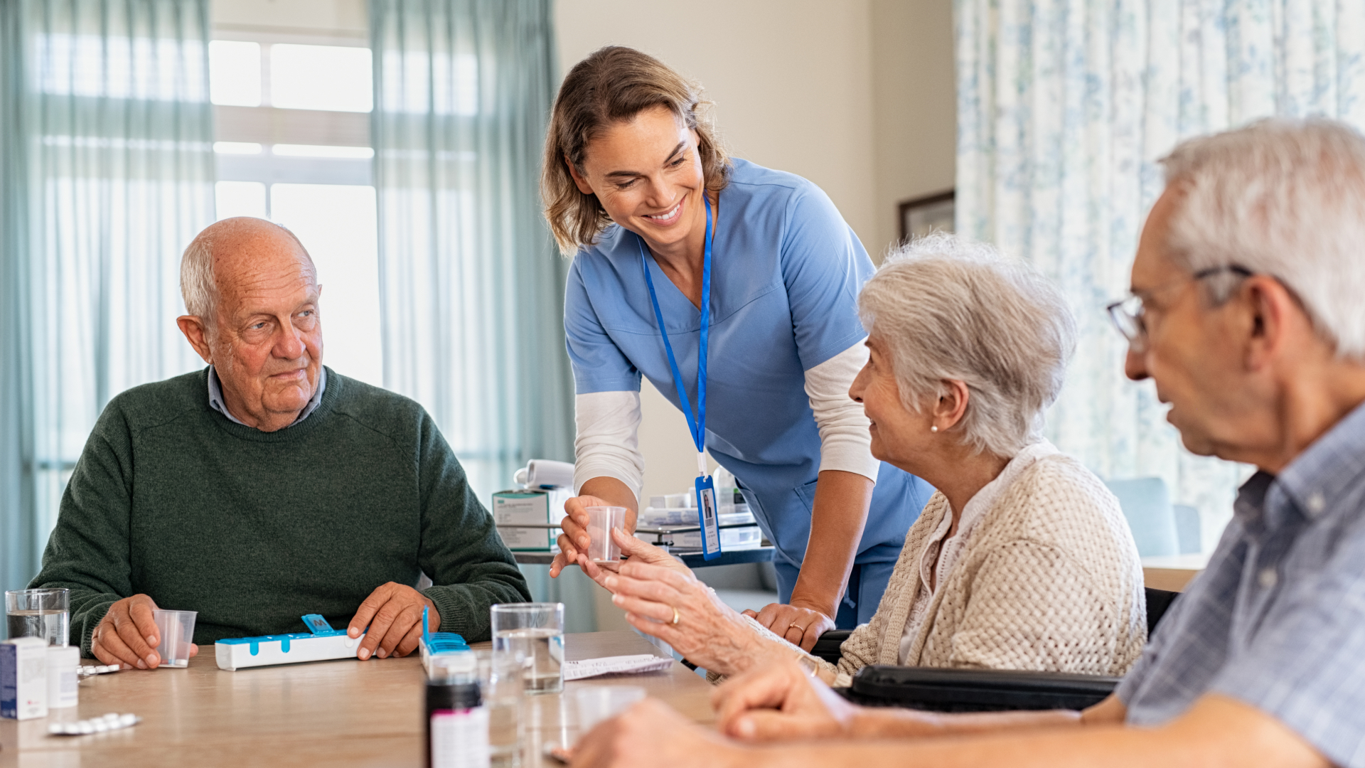 Nurse helping seniors with medication in a skilled nursing facility to reduce hospital readmissions