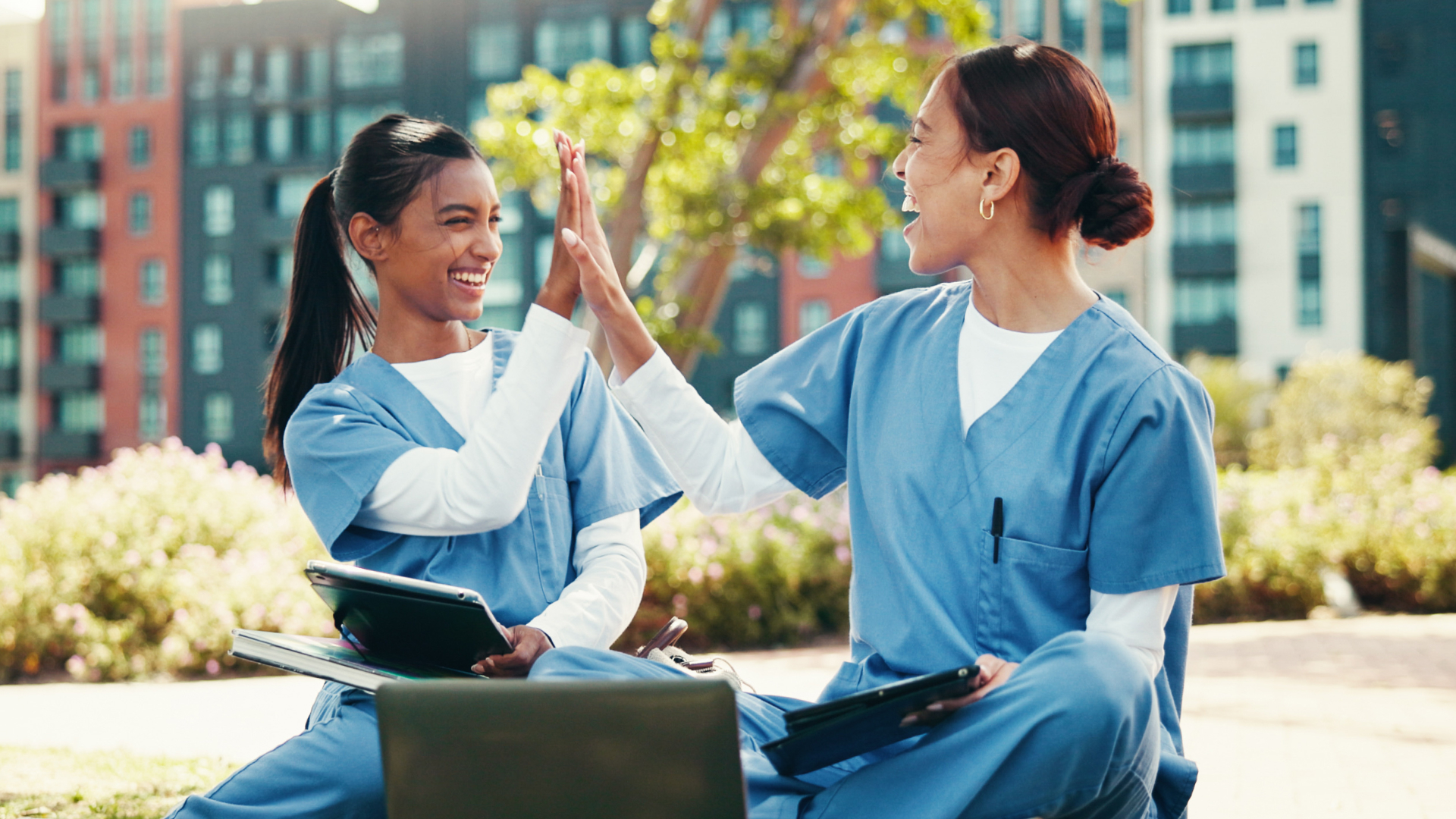 Two smiling nurses high fiving, representing successful nursing retention strategies