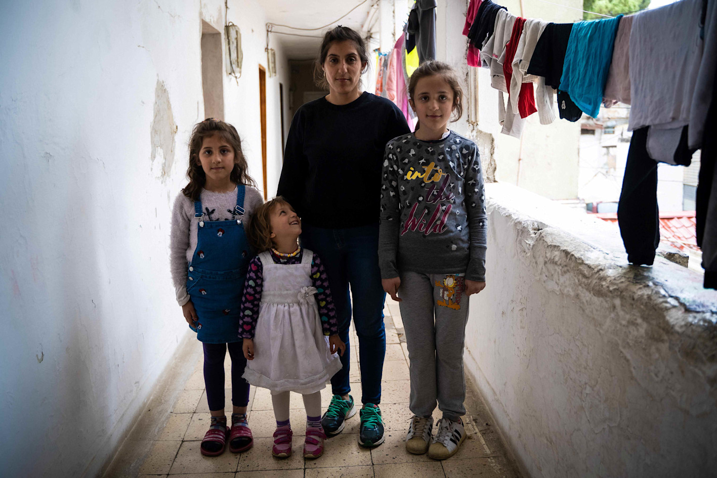 Mother and her three daughters in front of their home in Tirana