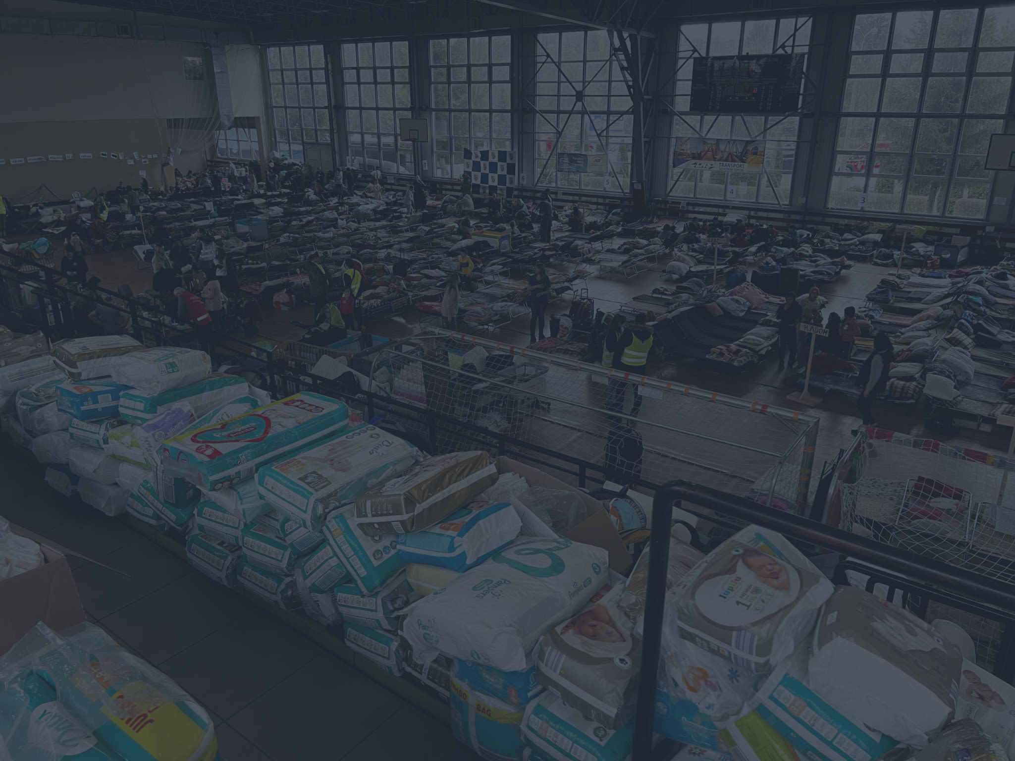 Baby supplies in the foreground of a refugee shelter