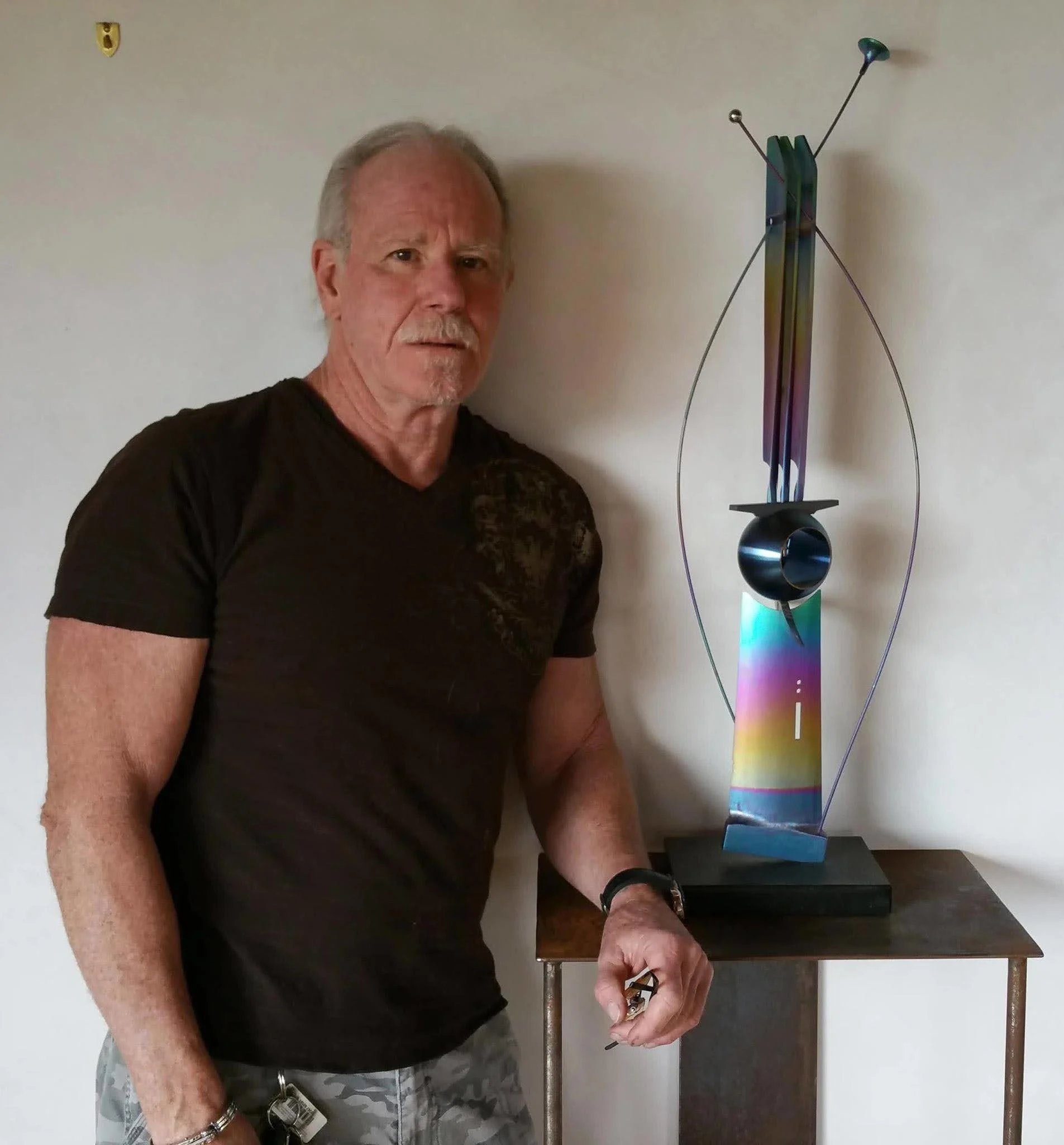 Michael Walker beside one of his sculptures