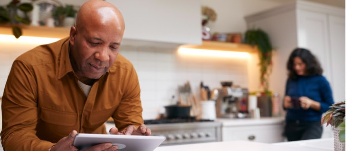 Male consumer looks at a tablet