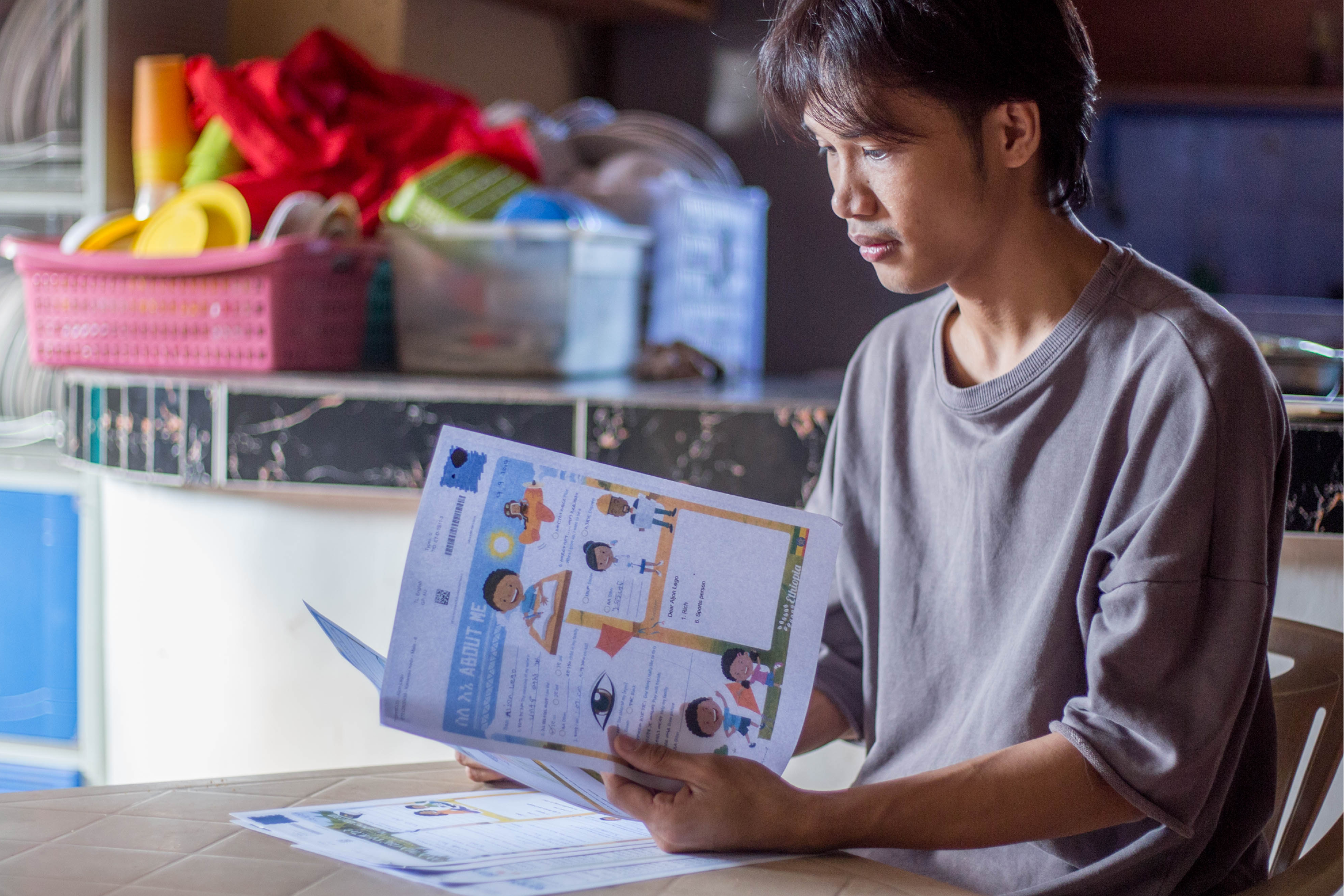 Aljon, reading through Compassion sponsorship letters