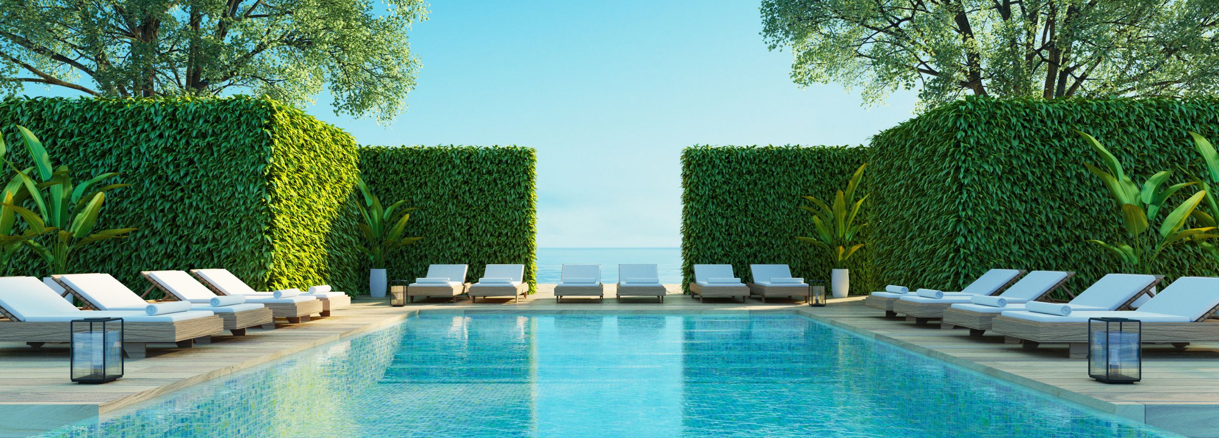 Luxury sea view pool with modern wood poolside lounge chairs.