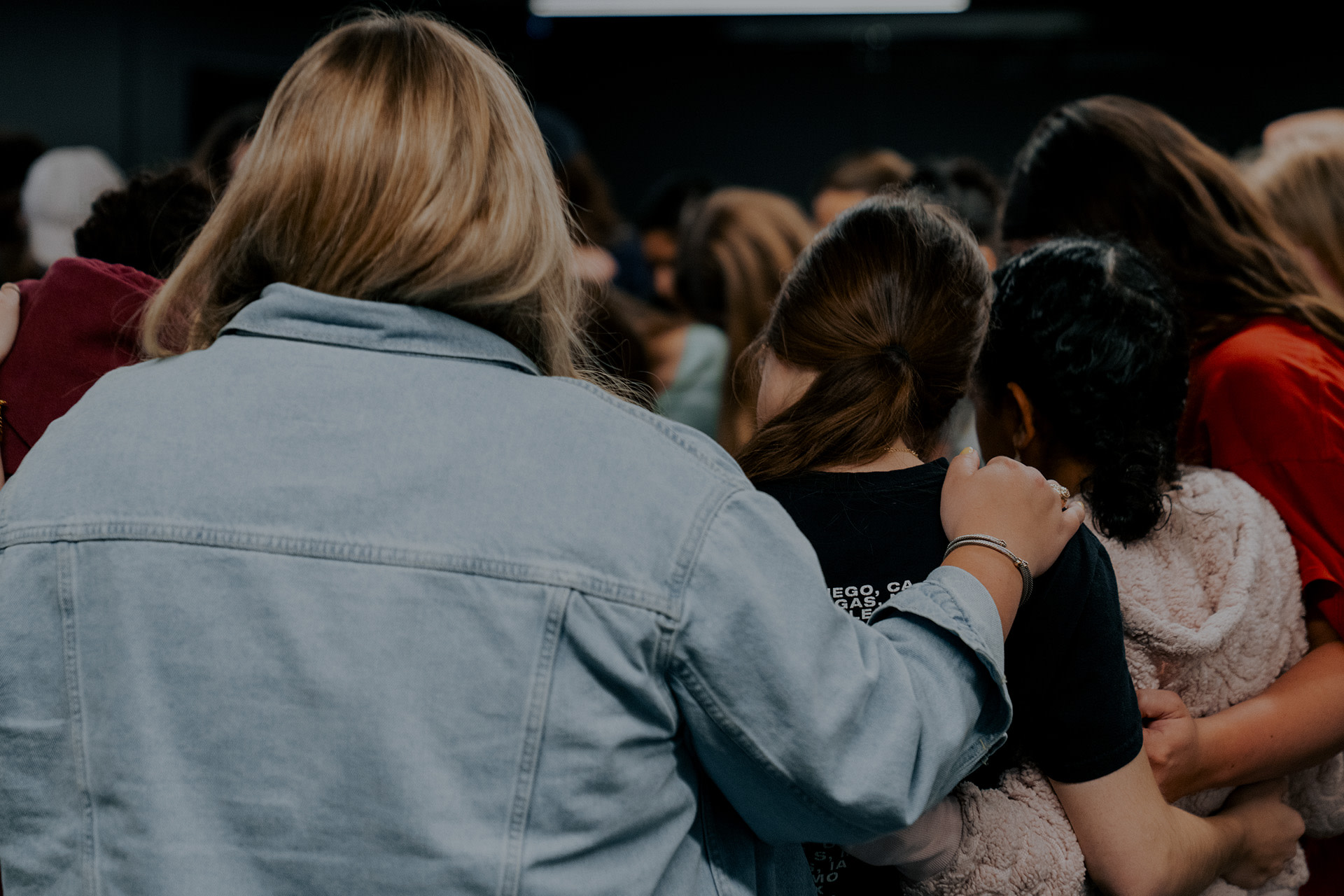 Parents gathered in prayer during a Re:generation for Students meeting at Watermark Community Church in Dallas, Texas, offering support and care for one another.