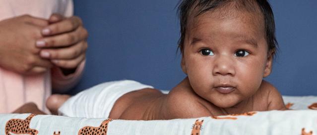 Newborn back getting a  massage on chest