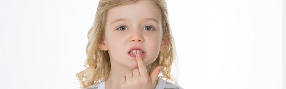 Toddler pulling her lower lip down with her finger