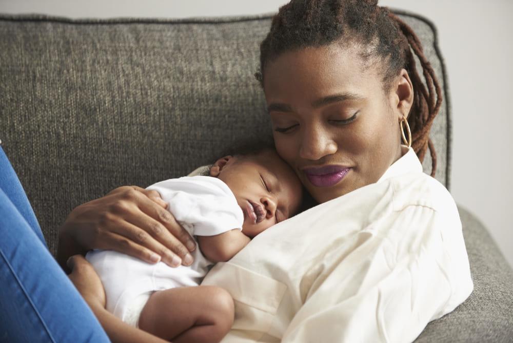 Baby sleeping on her mother's chest