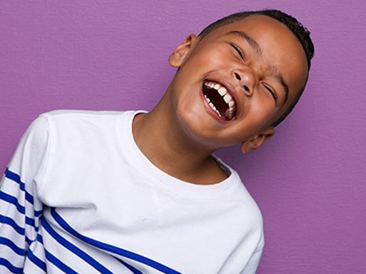 little boy with a striped shirt smiling