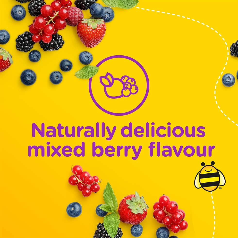 Mixed berries strewn across a yellow background with the text 'naturally delicious mixed berry flavour'