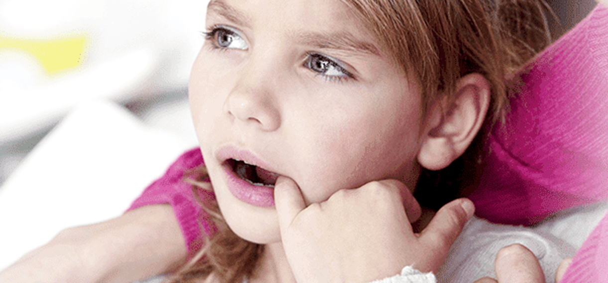 Little girl suffering from toothache