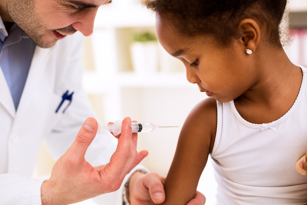 Little girl getting a shot in the arm