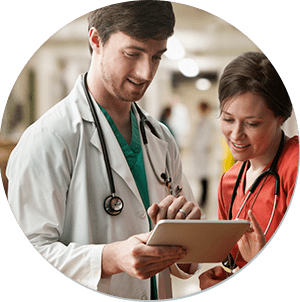 Doctor showing a nurse information on a clipboard