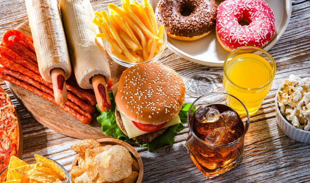 A banner displaying acidic food and drink such as burger, fries and orange juice that can cause sensitive teeth