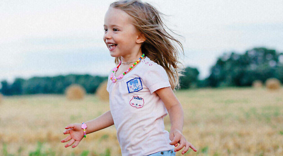 little girl running in the field