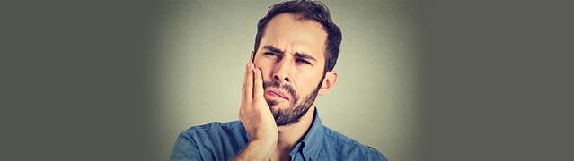 man looking concerned about tooth decay