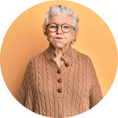 Older woman standing and holding mouthwash in her mouth