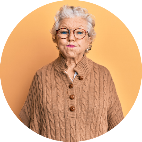 Older woman standing and holding mouthwash in her mouth