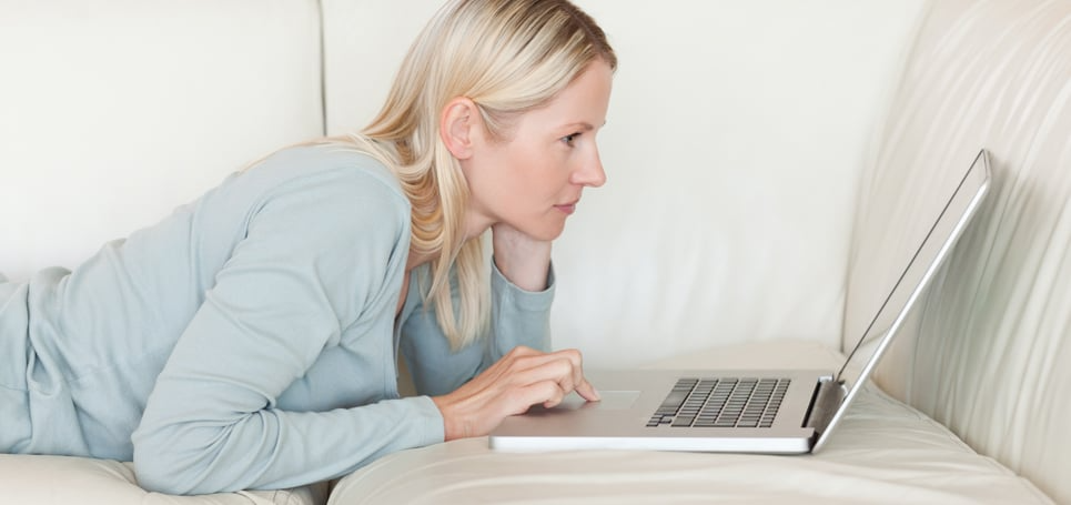 Femme qui utilise le pavé tactile d'un ordinateur portable