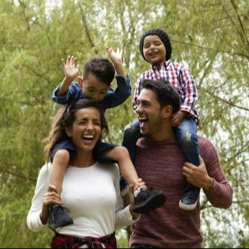 A family with two small kids having an outdoor walk