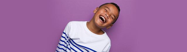 little boy with a striped shirt smiling