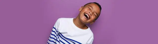 little boy with a striped shirt smiling