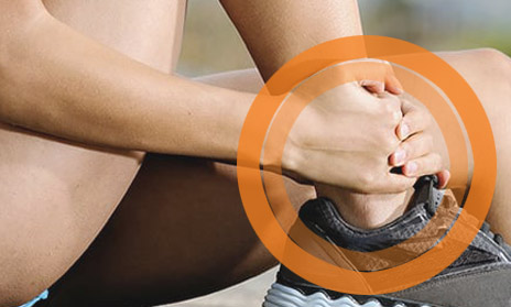 Woman holding her sprained ankle.